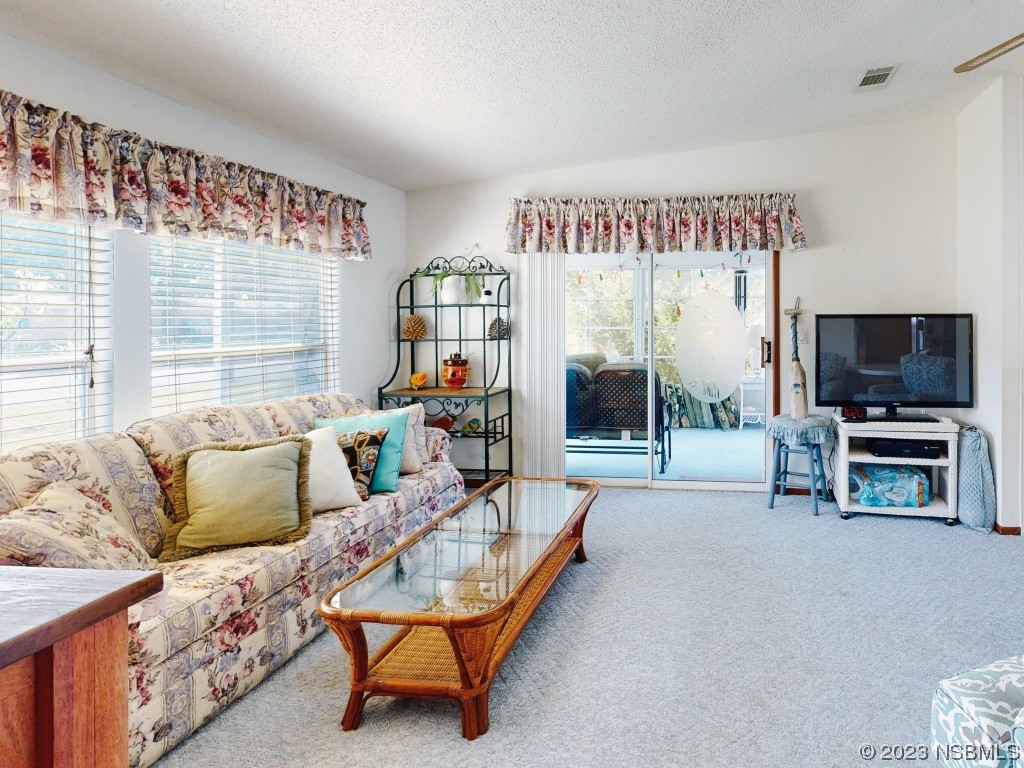 700 Starboard Avenue Edgewater, FL 32141 - Photo 4 of 47 a living room with furniture and a flat screen tv