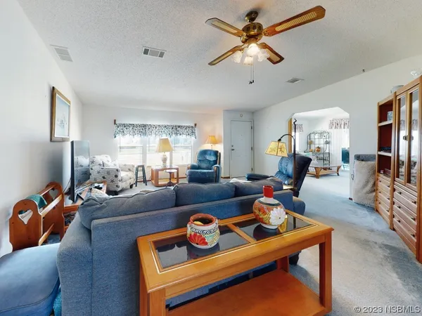 a living room with furniture a rug and a chandelier