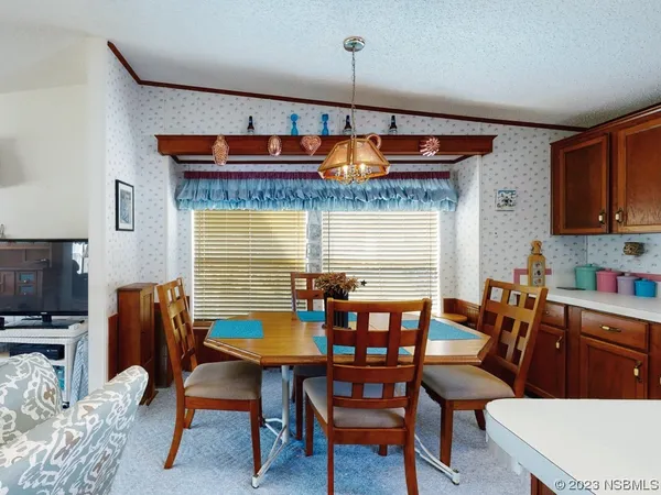 a dining room with furniture and window