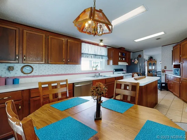 a kitchen with a sink cabinets and window