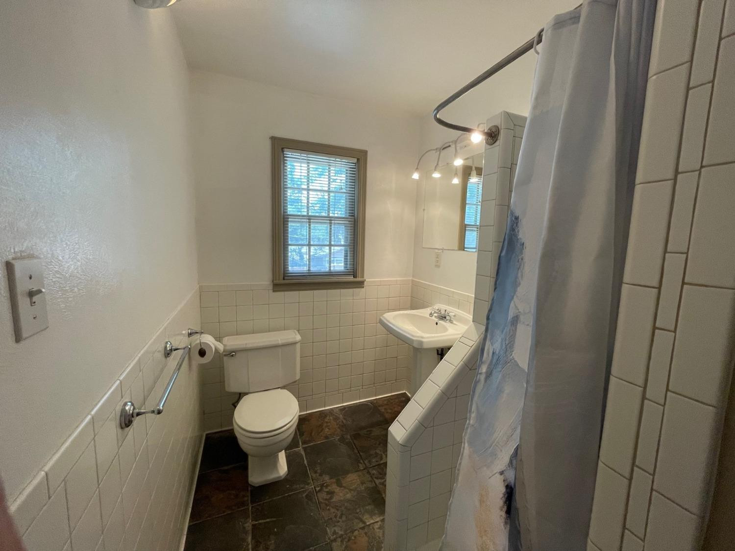 3018 29th Street Lubbock, TX 79410 - Photo 8 of 14 a bathroom with a toilet and a shower