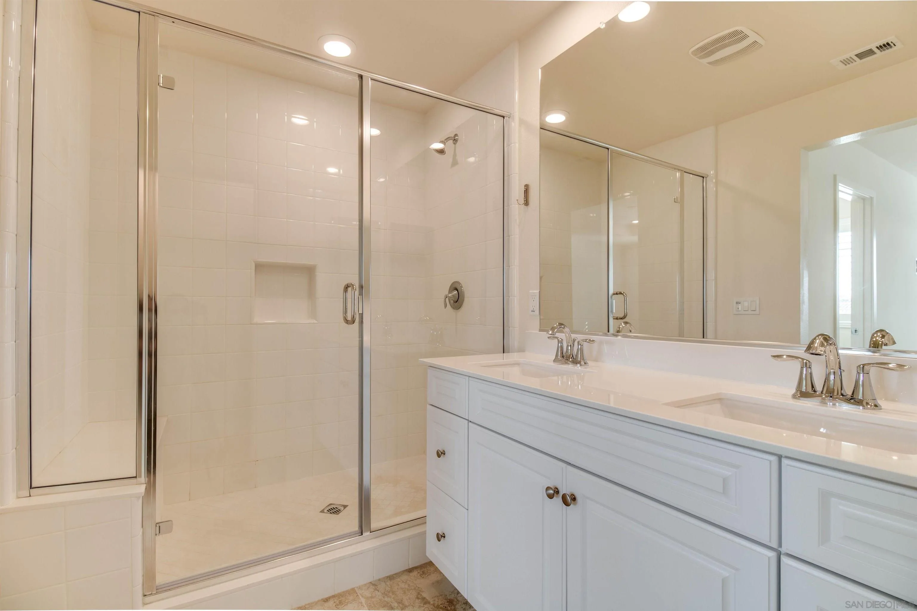 6012 Village Center Loop Road, Unit 35 San Diego, CA 92130 - Photo 13 of 29 a bathroom with a shower sink and mirror