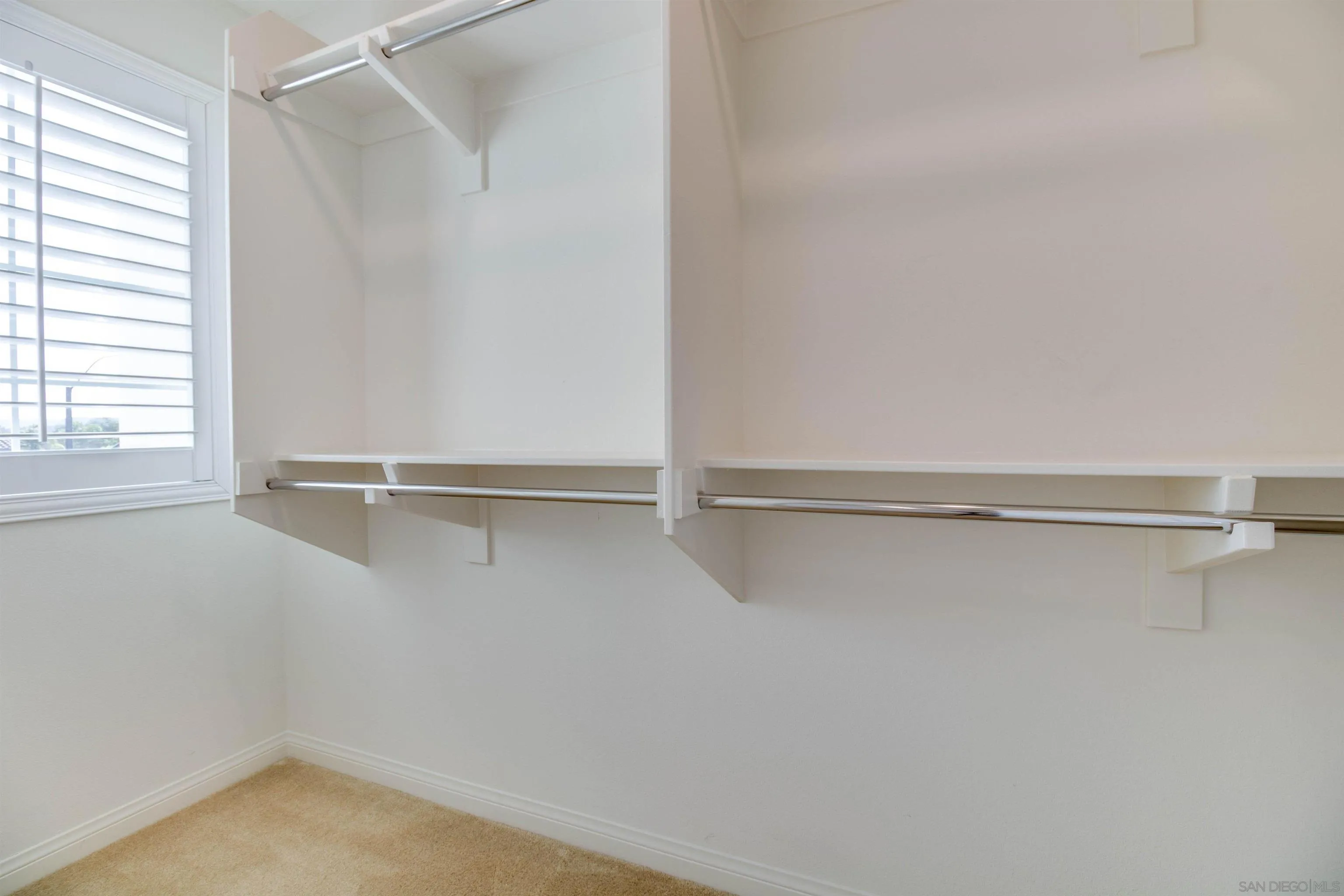 6012 Village Center Loop Road, Unit 35 San Diego, CA 92130 - Photo 20 of 29 a view of walk in closet with empty racks