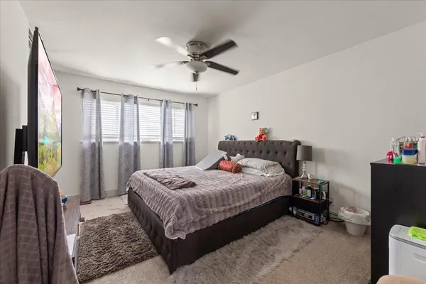 a bedroom with a bed and a window