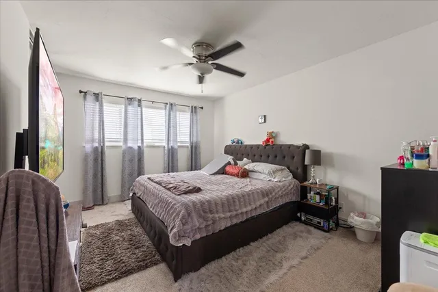 a bedroom with a bed and a window