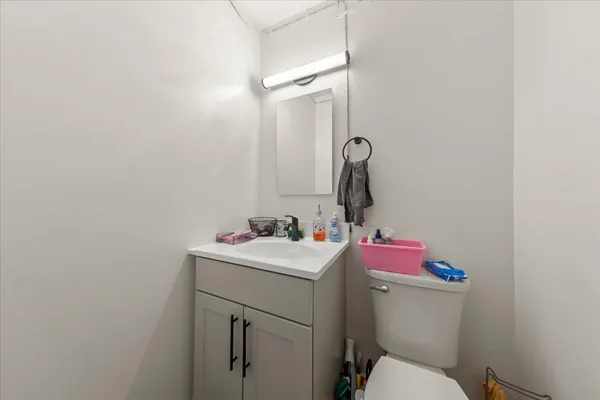 a bathroom with a sink toilet and a mirror