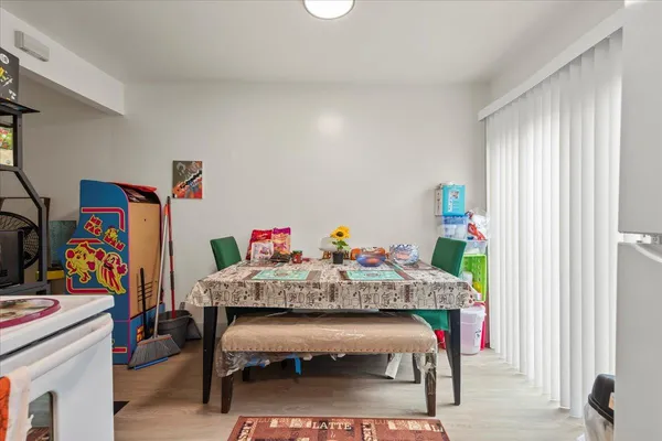 a view of a dining room with furniture and a window
