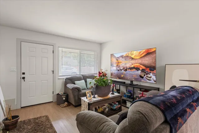 a living room with furniture a couch and a flat screen tv