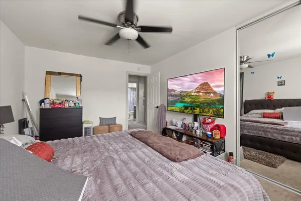 a bedroom with bed and a flat screen tv