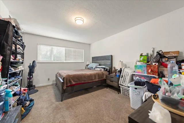 a bed room with a bed and a window