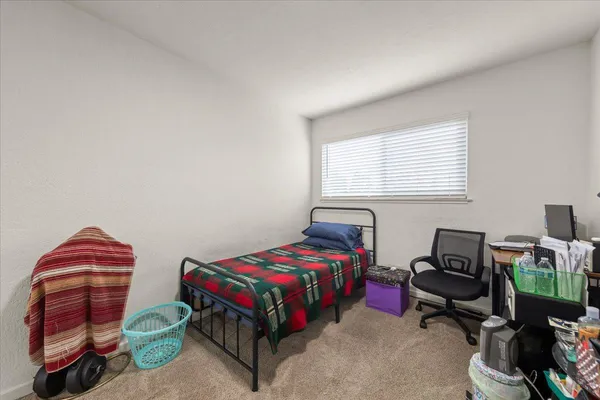 a bedroom with a bed and a window