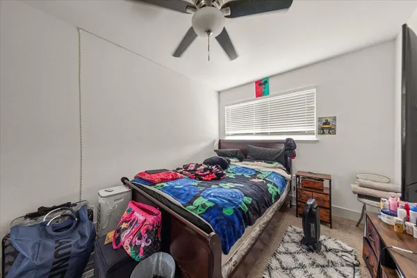 a bedroom with bed and a window