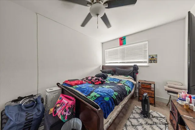 a bedroom with bed and a window