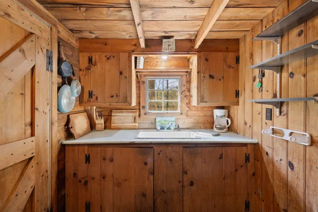 a bathroom with a granite countertop sink a mirror and shower