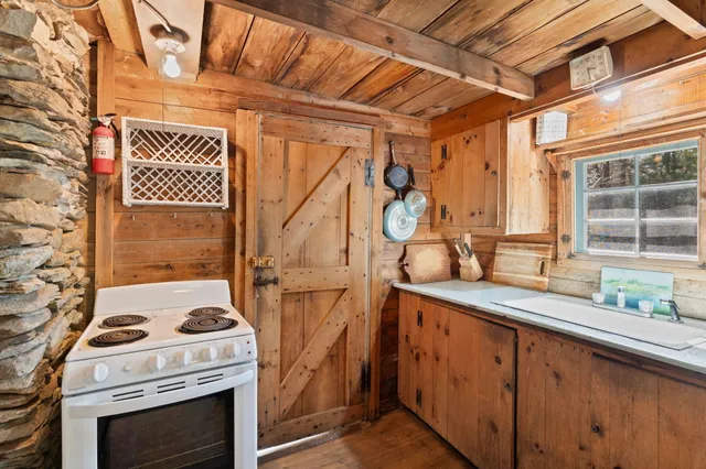 a view of a kitchen with a sink and a stove top oven