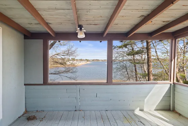 a view of a room with wooden floor and windows