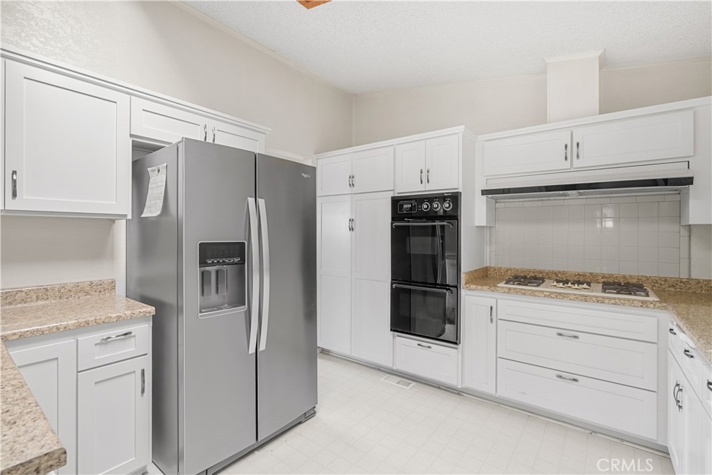 820 Vista Del Rio Santa Maria, CA 93458 - Photo 19 of 57 a kitchen with white cabinets and refrigerator