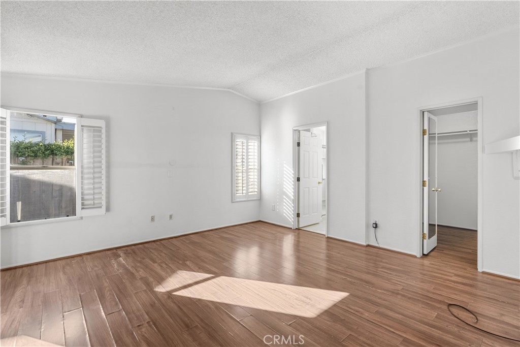 820 Vista Del Rio Santa Maria, CA 93458 - Photo 27 of 57 an empty room with wooden floor and windows