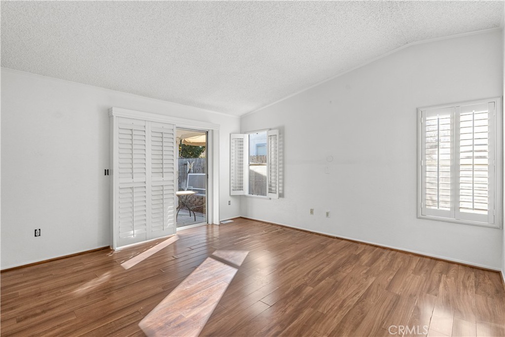 820 Vista Del Rio Santa Maria, CA 93458 - Photo 28 of 57 an empty room with wooden floor and windows