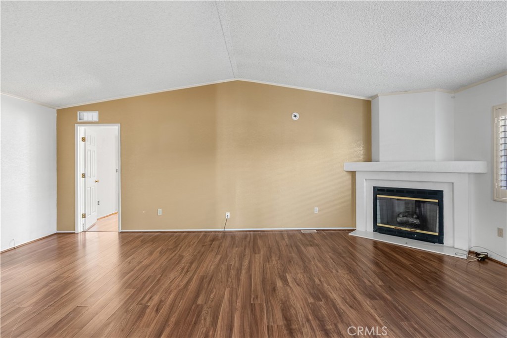 820 Vista Del Rio Santa Maria, CA 93458 - Photo 7 of 57 a view of empty room with wooden floor and fireplace