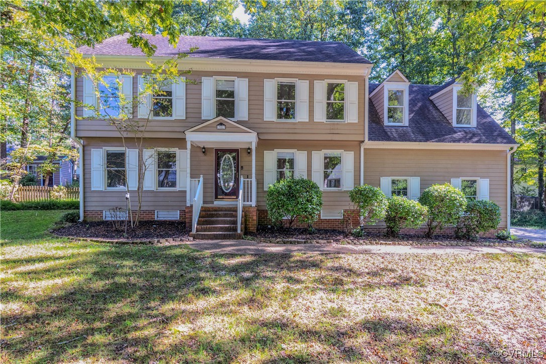 Colonial-style house with a front yard