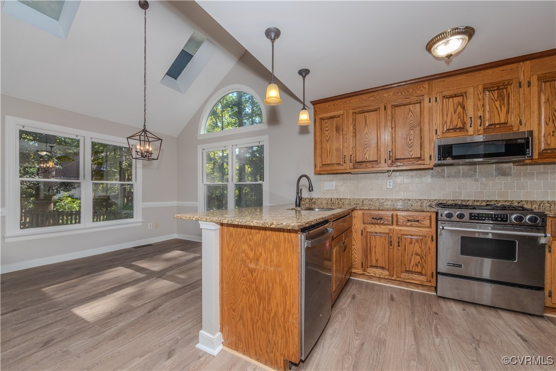 13817 Laurel Spring Road Chester, VA 23831 - Photo 12 of 40 Kitchen featuring light stone counters, a skylight