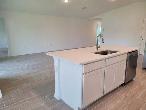 a kitchen with a sink and cabinets