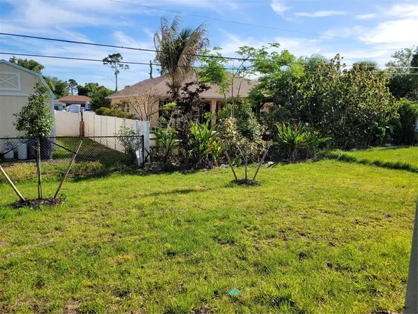 a view of a chair and table in backyard