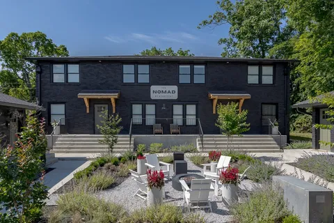 a view of a chairs and table in the back yard of the house