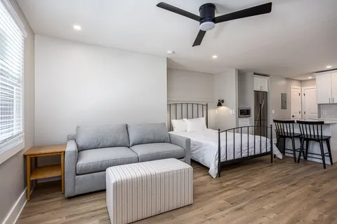 a kitchen with a refrigerator stove and wooden cabinets