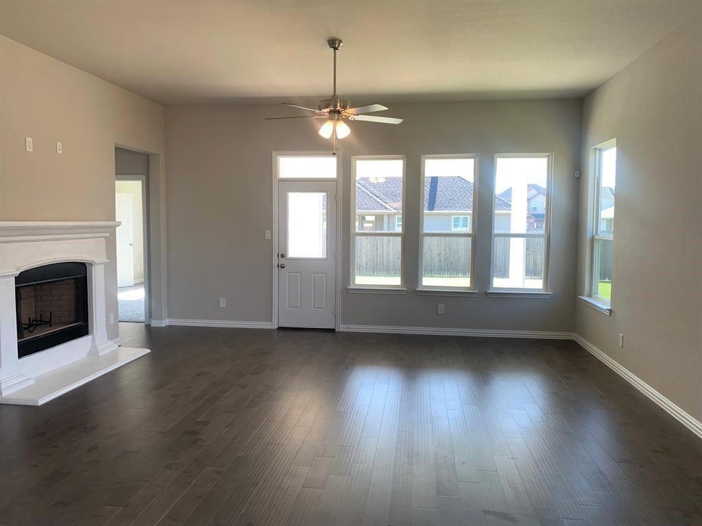 906 Gambel Drive Sherman, TX 75092 - Photo 4 of 26 a view of an empty room with wooden floor and a window