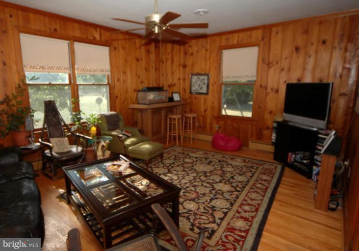 113 Morven Park Road Northwest Leesburg, VA 20176 - Photo 9 of 16 a living room with furniture a flat screen tv and a floor to ceiling window