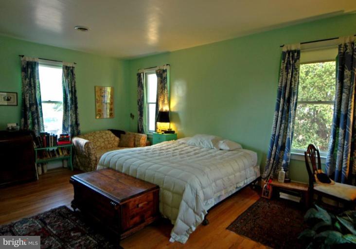 113 Morven Park Road Northwest Leesburg, VA 20176 - Photo 10 of 16 a bedroom with a bed window and a table in it