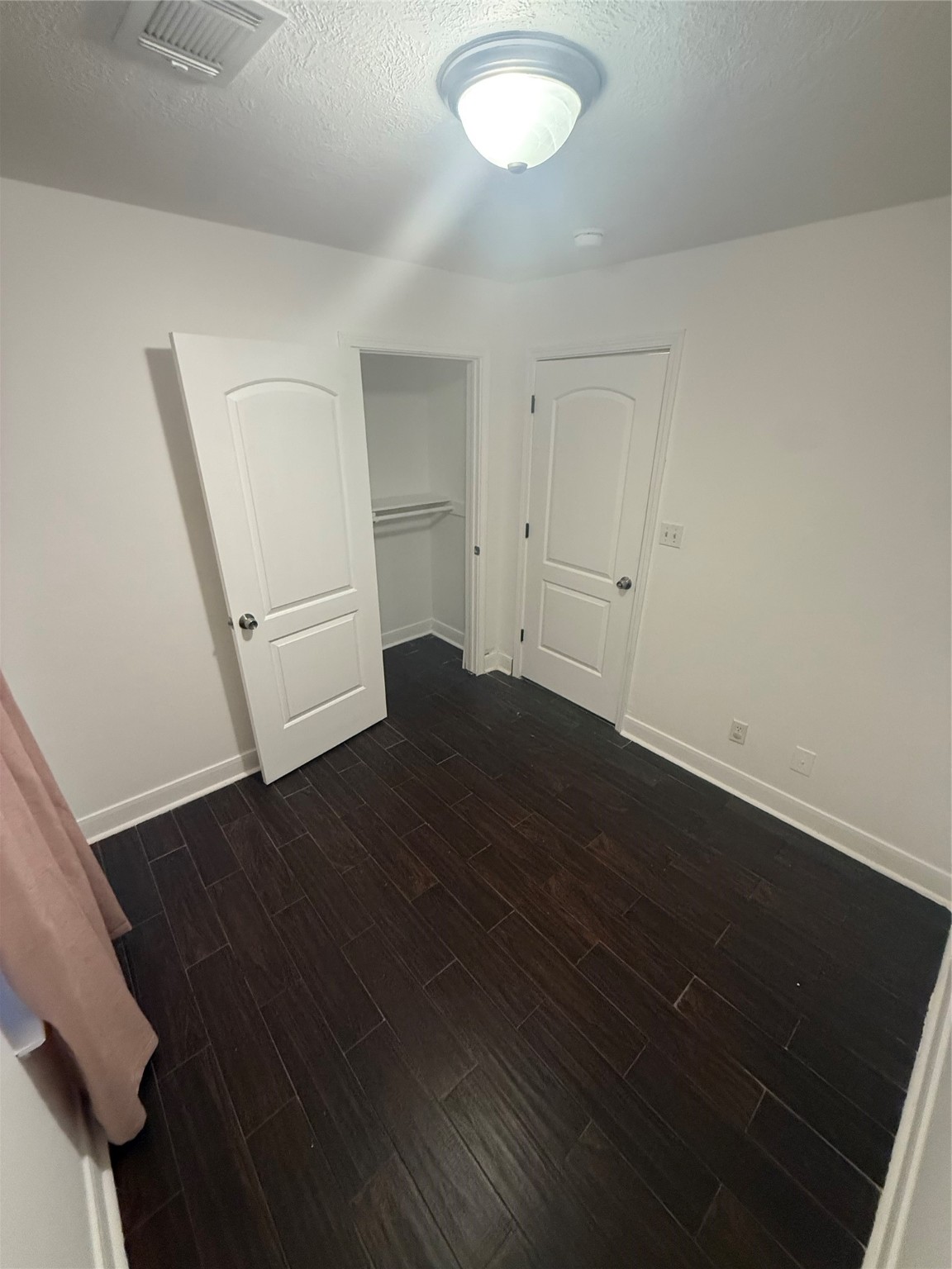 919 Lovett Street Tomball, TX 77375 - Photo 7 of 21 an empty room with wooden floor and windows