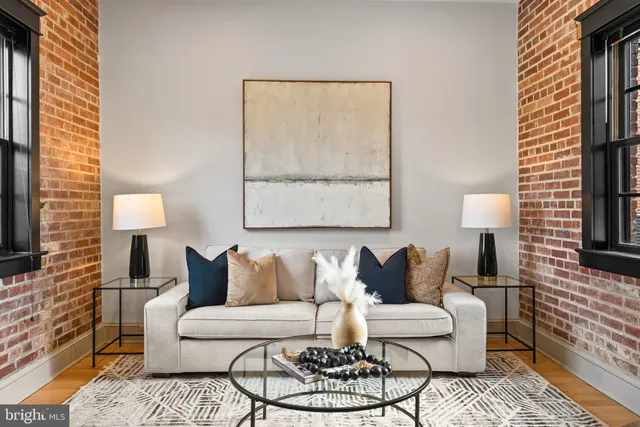 a living room with furniture and a lamp