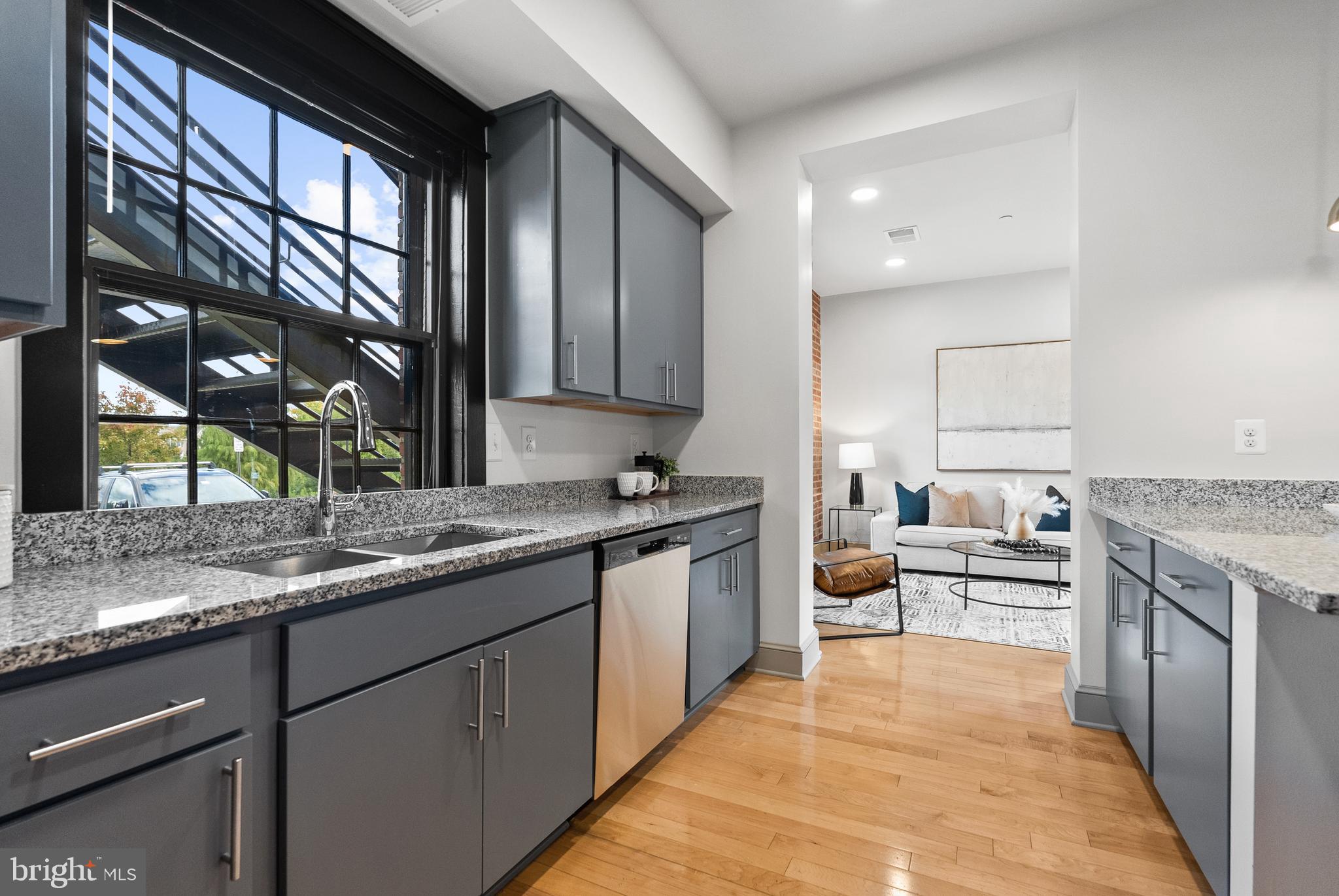 9071 Power House Road, Unit 102 Lorton, VA 22079 - Photo 12 of 53 a kitchen with a sink stove and cabinets