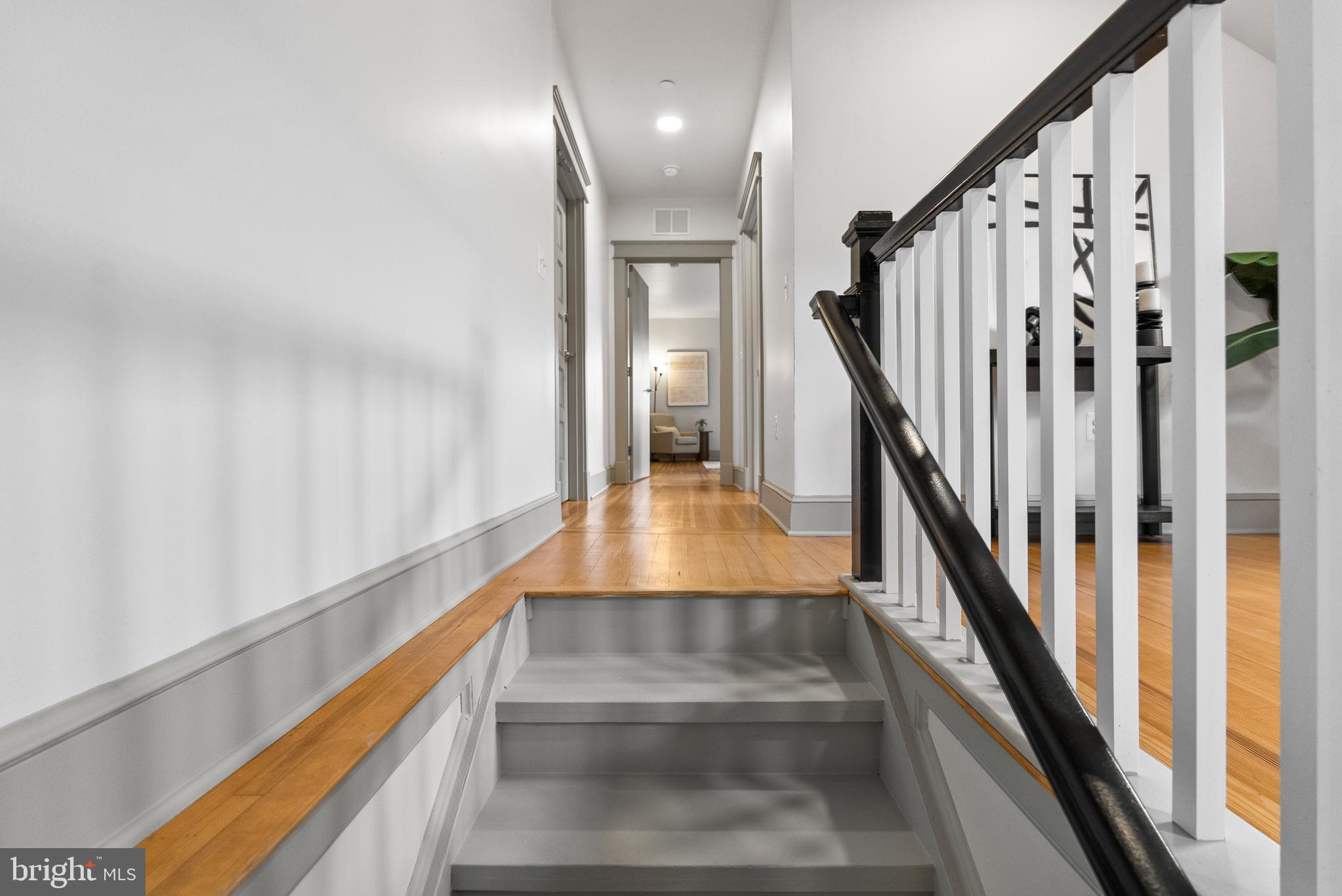 9071 Power House Road, Unit 102 Lorton, VA 22079 - Photo 28 of 53 a view of staircase with lots of frames on wall and windows