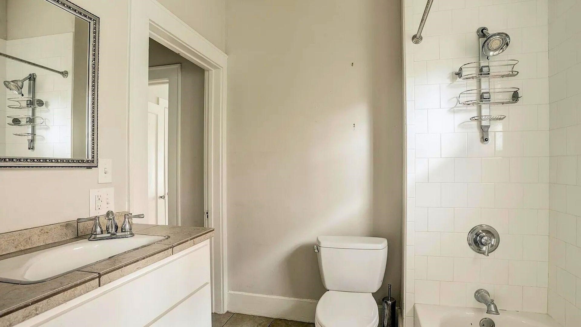 2220 Avalon Place Houston, TX 77019 - Photo 10 of 12 a bathroom with a granite countertop sink toilet and shower