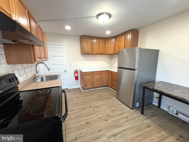 a kitchen with a sink appliances and cabinets