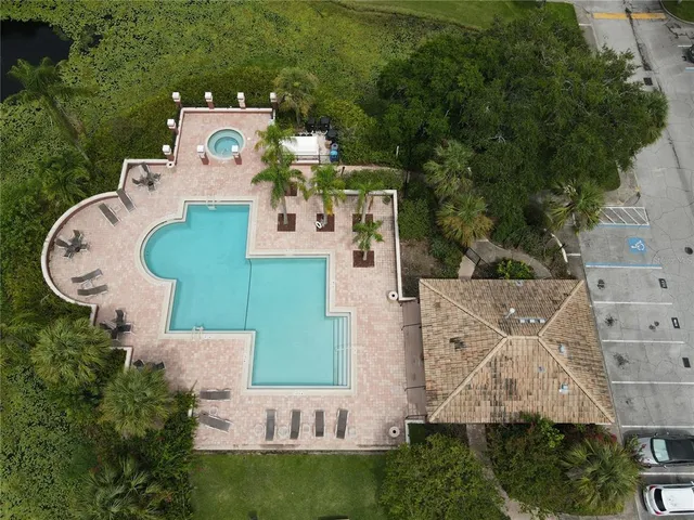 an aerial view of a house with outdoor space pool seating area and yard