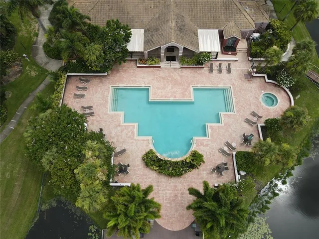 an aerial view of a house with yard swimming pool and outdoor seating