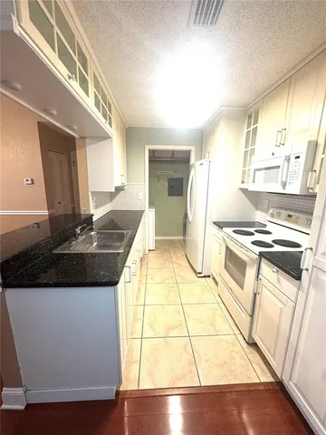 a kitchen with a sink and a stove top oven