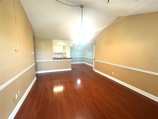 a view of a room with wooden floor
