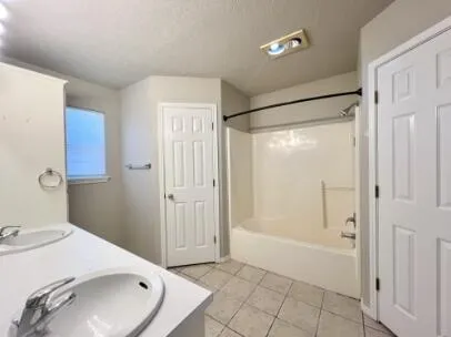 a bathroom with a sink and shower