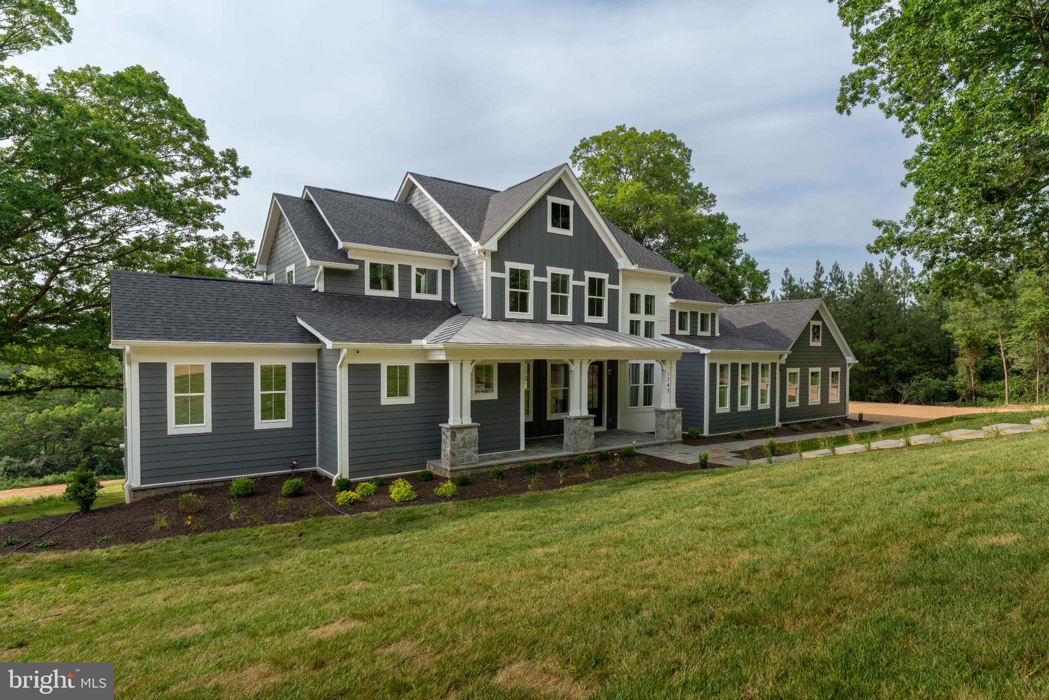 623 Traveller Court Lothian, MD 20711 - Photo 3 of 76 Elegant modern home nestled in lush greenery.