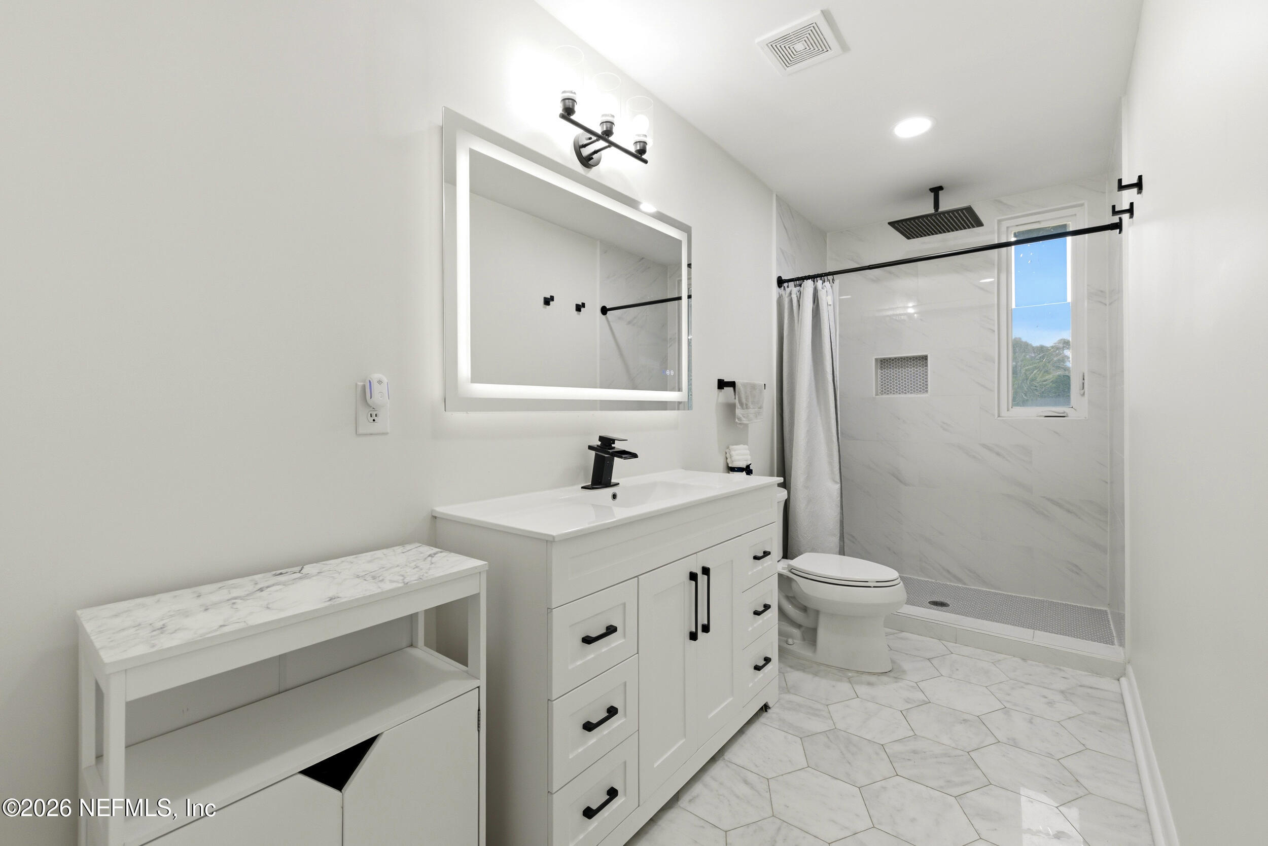 7484 Spinola Road Jacksonville, FL 32217 - Photo 32 of 63 a bathroom with a sink toilet and shower
