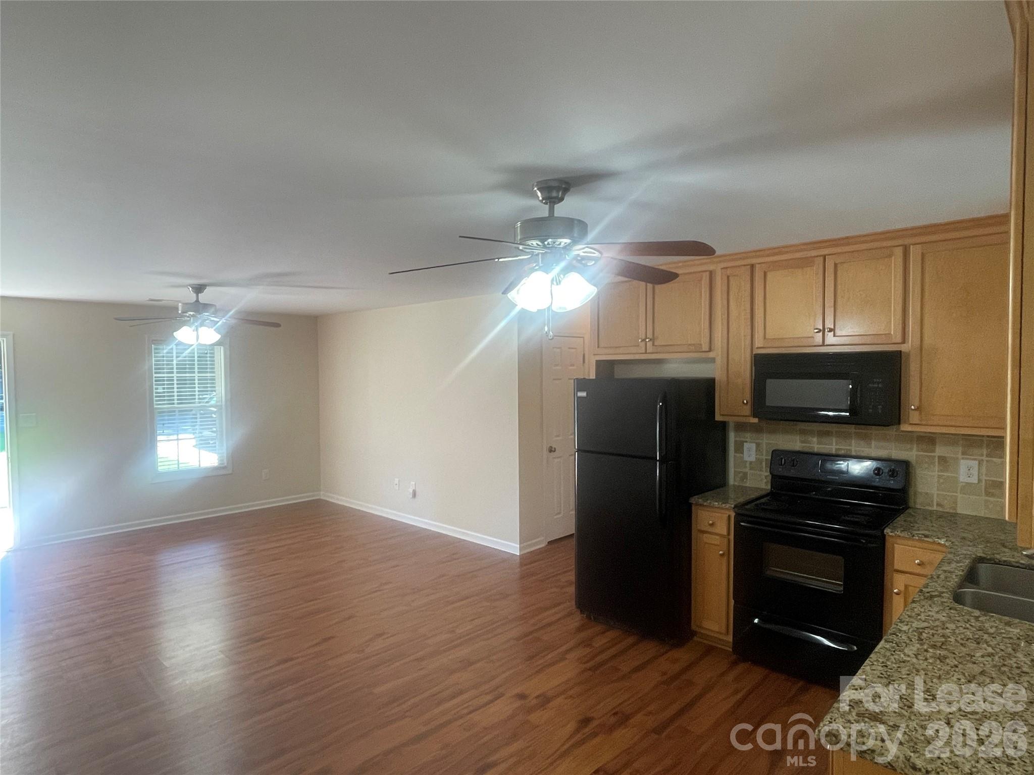 3791 Lee Moore Road Maiden, NC 28650 - Photo 5 of 11 a kitchen with stainless steel appliances a refrigerator cabinets and wooden floor