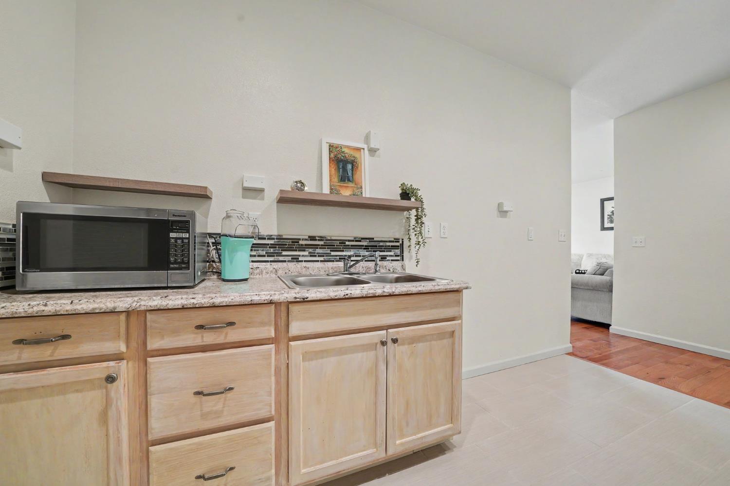 6066 Bluff View Road Copperopolis, CA 95228 - Photo 53 of 96 a kitchen with white cabinets and sink