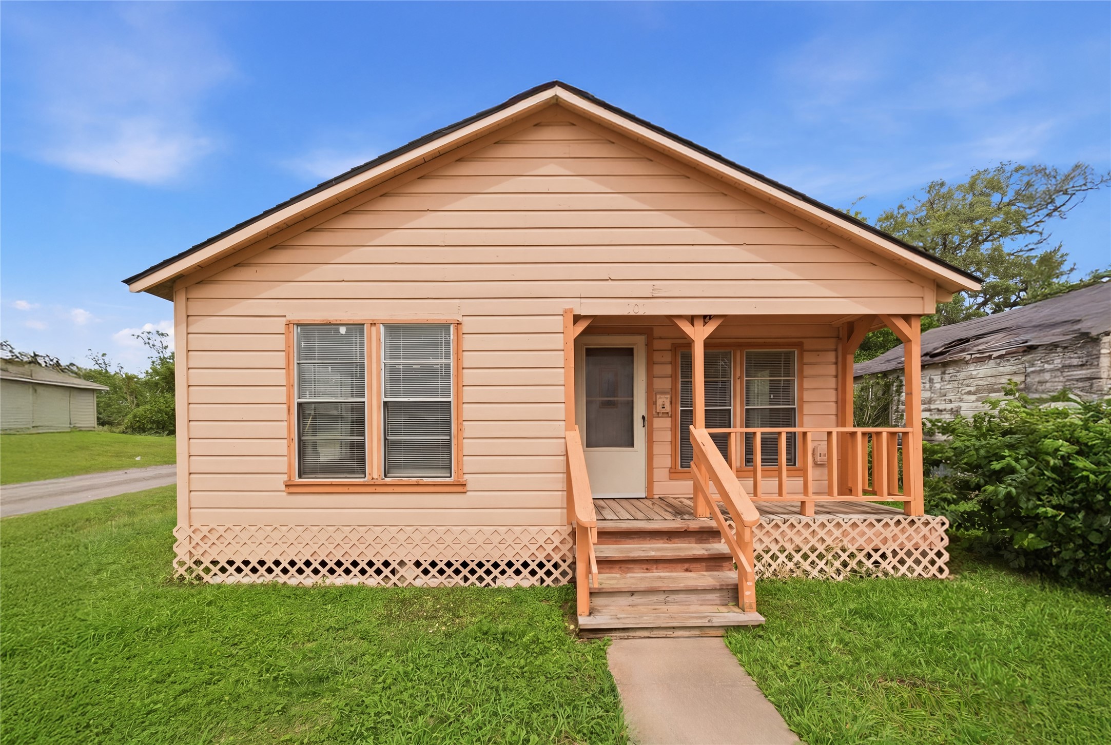 101 Outlar Street Wharton, TX 77488 - Photo 1 of 40 a front view of a house with a garden