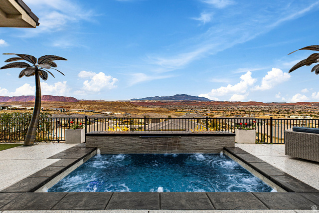 3022 West Sesia Way St. George, UT 84770 - Photo 33 of 52 View of pool featuring patio surround, a swimming pool, a mountain view, and a jacuzzi